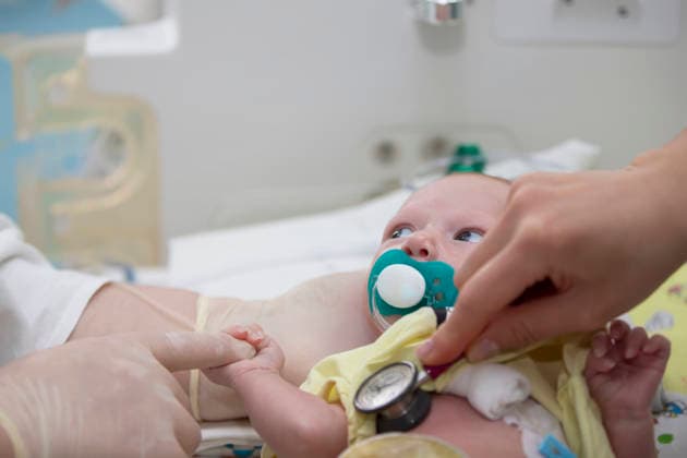 May 31, 2021. Belarus, Gomil. Neonatal Intensive Care Unit. The doctor listens to the heart of a newborn baby. May 31, 2021. Belarus, Gomil. Neonatal Intensive Care Unit. The doctor listens to the heart of a newborn baby., model released, , 97468280.jpg RECORD DATE NOT STATED