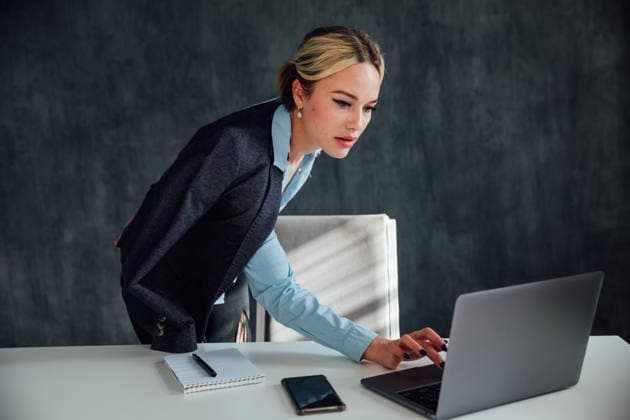 Blonde business woman working with laptop online at desk in office Blonde businesswoman working with laptop online at desk in office, model released, , 97863232.jpg RECORD DATE NOT STATED