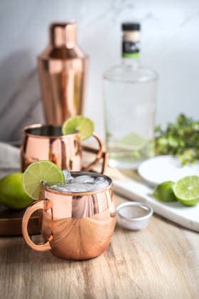 Moscow mule cocktail in copper mug preparing with lime Fort Collins, Colorado, United States CR_YVOQ260106-1920900-01