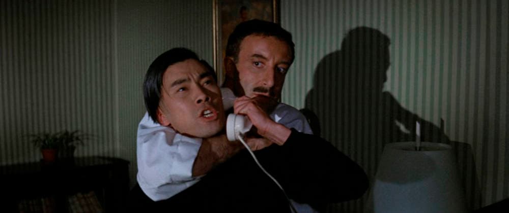 Peter Sellers and Burt Kwouk Los Angeles.CA.USA. Peter Sellers and Burt Kwouk in a scene in (C) United Artists film, A Shot in the Dark (1964). Director: Blake Edwards Writers: Blake Edwards and William Peter Blatty Source: Marcel Achard play L™Idiote and Harry Kurnitz play with same title. LMK110-S080126-001 Supplied by LMKMEDIA. Editorial Only. Landmark Media is not the copyright owner of these Film or TV stills but provides a service only for recognised Media outlets. 