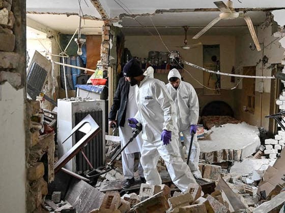 (260111) -- ISLAMABAD, Jan. 11, 2026 -- Security personnel examine the site of a gas explosion in Islamabad, capital of Pakistan on Jan. 11, 2026. The death toll from a gas explosion at a wedding house in Pakistan s federal capital, Islamabad, has risen to eight, including a newlywed couple, while 11 others were injured, local authorities said on Sunday. Rescue officials said at least four houses in the surrounding area were affected by the blast. Authorities said the exact cause of the explosion will be determined following a detailed investigation. (Str Xinhua) PAKISTAN-ISLAMABAD-GAS EXPLOSION-AFTERMATH AhmadxKamal 