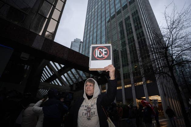 January 11, 2026, Vancouver, Bc, CANADA: A person holds a sign while demonstrating during an Ice Out For Good rally outside of the U.S. Consulate General office in Vancouver, on Sunday, January 11, 2026. Vancouver CANADA  - ZUMAc35_ 20260111_zaf_c35_034 Copyright: xEthanxCairnsx