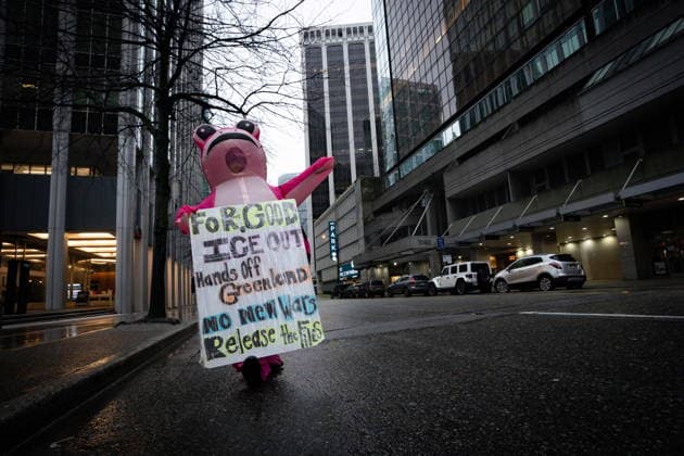 January 11, 2026, Vancouver, Bc, CANADA: A person wearing an inflatable pink frog costume waves at oncoming traffic during an Ice Out For Good rally in Vancouver, on Sunday, January 11, 2026. Vancouver CANADA  - ZUMAc35_ 20260111_zaf_c35_033 Copyright: xEthanxCairnsx