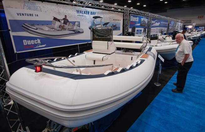 (260115) -- VANCOUVER, Jan. 15, 2026 -- A man looks at an inflatable speedboat on display during the Vancouver International Boat Show 2026 at the Vancouver Convention Centre in Vancouver, British Columbia, Canada, Jan. 14, 2026. The five-day show kicked off here on Wednesday, with hundreds of exhibitors from around the world showcasing the latest vessels, marine gears and marine technology. (Photo by Xinhua) CANADA-VANCOUVER-INT L BOAT SHOW 2026 LiangxSen 