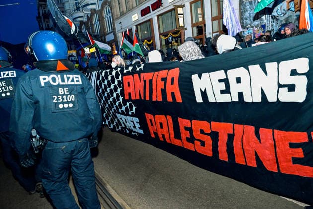 January 17, 2026, Leipzig, Saxony, Germany: A police officer from BerlinÃ¢â‚¬â ¢s unit walk past by a banner that reads Ã¢â‚¬oeAntifa means free Palestine!Ã¢â‚¬Â? in Leipzig, Jan. 17 2026. Leftists, anarchists and people in solidarity with the Palestinian causes marched through the streets of Leipzig to protest the on going genocidal war of Israel in Gaza Strip. The protestors were followed by heavy police forces who joined also from other federal states of Germany and by few people part of a leftist organisation called anti-Deutsche (Anti-Germans) who support the state of Israel. Leipzig Germany - ZUMAk201 20260117_zip_k201_017 Copyright: xNikosxKanistrasx