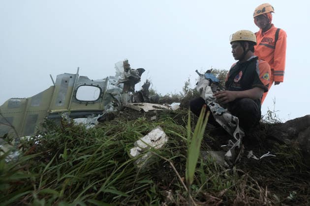 (260119) -- SOUTH SULAWESI, Jan. 19, 2026 -- Rescue team members stand near the debris of the crashed ATR 42-500 aircraft near the summit of Mount Bulusaraung in Pangkep regency, South Sulawesi, Indonesia, Jan. 18, 2026. Indonesian rescuers have found one victim from the crashed ATR 42-500 aircraft on Mount Bulusaraung in Pangkep regency, South Sulawesi, authorities said on Sunday. The ATR 42-500 aircraft reportedly lost contact over Maros regency in South Sulawesi province. The plane was operating a flight from Yogyakarta to Makassar when communication with air traffic control was cut off on Saturday. According to official data, 10 people were on board the aircraft at the time it lost contact, comprising seven crew members and three
