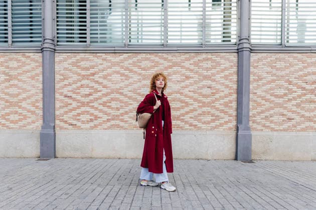 Woman wearing long coat standing on footpath at street model released, Symbolfoto property released, ASGF05904