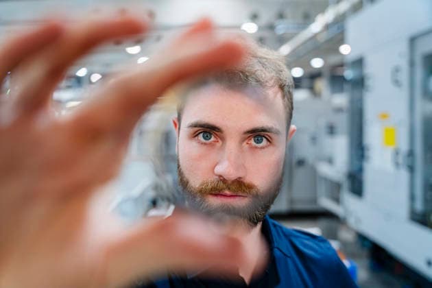 Engineer examining and working in factory model released, Symbolfoto property released, DIGF23264