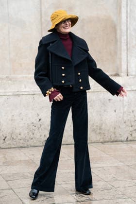 PFW - Patou Arrivals Inès de la Fressange wears red turtleneck sweater, black pants, black cropped coat, yellow bucket hat, outside Patou Menswear Fall Winter 2026-2027 show as part of Paris Fashion Week on January 25, 2026 in Paris, France. Photo by LounisPhotography ABACAPRESS.COM Paris France  Copyright: xLounisPhotography ABACAx