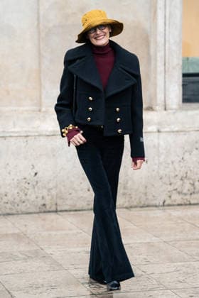 PFW - Patou Arrivals Inès de la Fressange wears red turtleneck sweater, black pants, black cropped coat, yellow bucket hat, outside Patou Menswear Fall Winter 2026-2027 show as part of Paris Fashion Week on January 25, 2026 in Paris, France. Photo by LounisPhotography ABACAPRESS.COM Paris France  Copyright: xLounisPhotography ABACAx