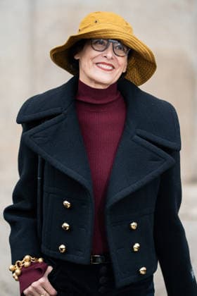 PFW - Patou Arrivals Inès de la Fressange wears red turtleneck sweater, black pants, black cropped coat, yellow bucket hat, outside Patou Menswear Fall Winter 2026-2027 show as part of Paris Fashion Week on January 25, 2026 in Paris, France. Photo by LounisPhotography ABACAPRESS.COM Paris France  Copyright: xLounisPhotography ABACAx