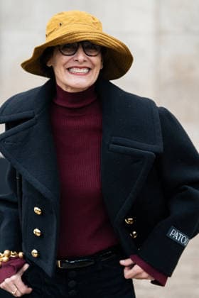 PFW - Patou Arrivals Inès de la Fressange wears red turtleneck sweater, black pants, black cropped coat, yellow bucket hat, outside Patou Menswear Fall Winter 2026-2027 show as part of Paris Fashion Week on January 25, 2026 in Paris, France. Photo by LounisPhotography ABACAPRESS.COM Paris France  Copyright: xLounisPhotography ABACAx
