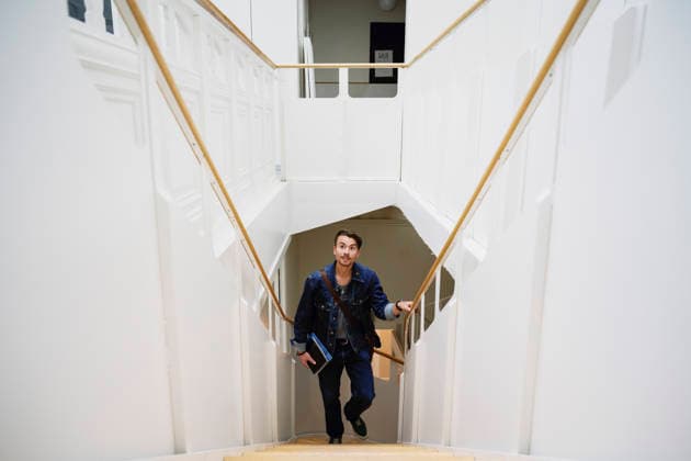 High angle view of young male student moving up stairs of university building Sweden, Stockholm, model released, property released Copyright: xMaskotx , MA122825 MA122825