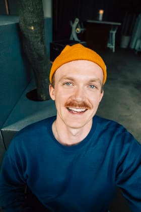 Portrait of smiling businessman wearing knit hat taking selfie in office Sweden, Stockholm, model released, property released Copyright: xMaskotx , MA123152 MA123152