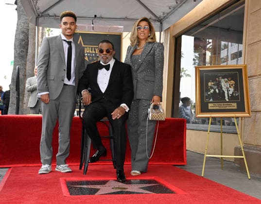 Singer-songwriter Ronald Isley of the US band The Isley Brothers is joined by his wife Kandy Isley (R) and their son Ronald Isley Jr. (L) during an unveiling ceremony honoring the band with the 2,834th star on the Hollywood Walk of Fame in Los Angeles on Wednesday, January 28, 2026.  LAP2026012807 JIMxRUYMEN