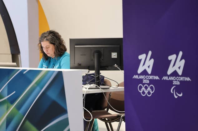 (260129) -- MILAN, Jan. 29, 2026 -- A staff works at a help desk in the main media center (MMC) of the Milan-Cortina 2026 Olympic Winter Games in Milan, Italy, Jan. 28, 2026. ) (SP)ITALY-MILAN-WINTER OLYMPICS-MAIN MEDIA CENTER DuxXiaoyi 