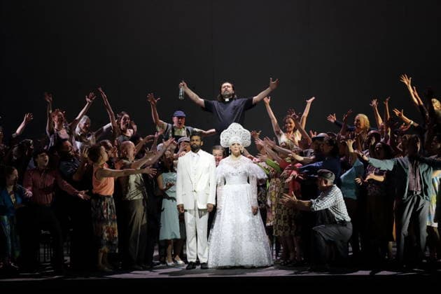 Sean Panikkar center left as Sergei , Ambur Braid center right as Katerina Lvovna Ismailova and Dimitry Ivashchenko center back as Pope and ensemble during the photo rehearsal for Lady Macbeth of Mtsensk at the Komische