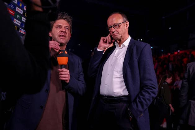 01 02 2026, Handball, Men s EHF EURO 2026, Germany Denmark, Jyske Bank Boxing in Herning, Final The German Chancellor Friedrich Merz Chancellor Politics Politician CDU grabs his head during the interview with ZDF Denmark
