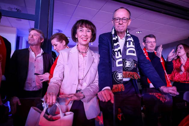 01 02 2026, Handball, Men s EHF EURO 2026, Germany Denmark, Jyske Bank Boxing in Herning, Final The German Chancellor Friedrich Merz Chancellor Politician CDU follows the game with a fan scarf around his neck together with his wife Charlotte Merz left Denmark