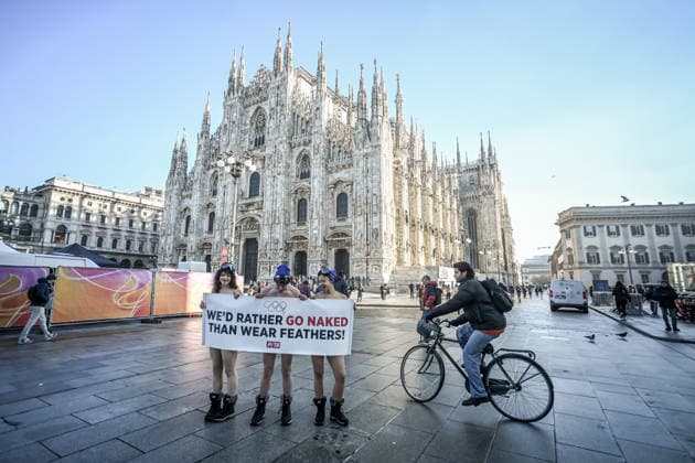 February 5, 2026, Milan, Mi, Italy: February 5, 2026, Milan. Piazza Duomo. Better Naked Than Wear Feathers, PETA s protest before the Olympics. A trio of nearly naked PETA supportersÃ¢â‚¬wearing only hats, ski goggles, and snow bootsÃ¢â‚¬stand behind a banner reading We d Rather Go Naked Than Wear Feathers! Milan Italy  - ZUMAa289 20260205_zia_a289_207 Copyright: xNicolaxMarfisix