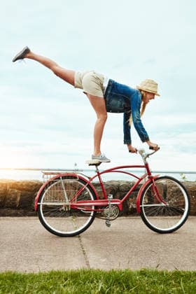 Vacation, outdoor or woman with bicycle trick, balance development or active hobby for weekend break. Challenge, fun activity or person with stunt execution on sidewalk, skill practice or holiday. model released property released Copyright: xx