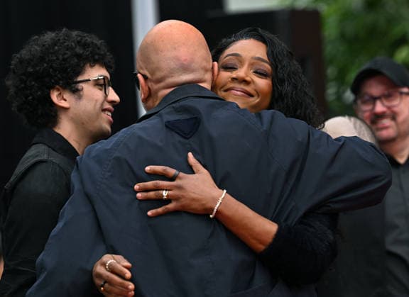 Tiffany Haddish hugs Jo Koy as they attend a hand and footprint ceremony honoring Koy in the forecourt of the TCL Chinese Theatre in Los Angeles, California on Wednesday, February 11, 2026.  LAP20260211723 CHRISxCHEW