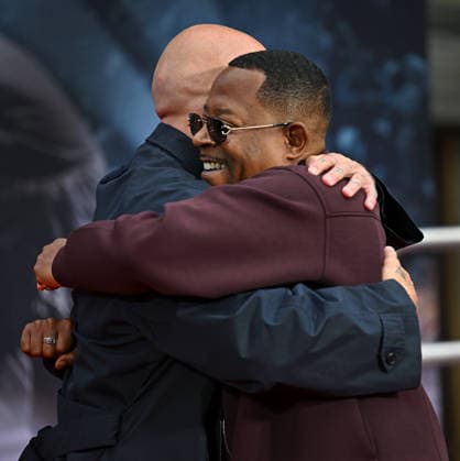 Jo Koy (L) and Martin Lawrence hug after the hand and footprint ceremony honoring Koy in the forecourt of the TCL Chinese Theatre in Los Angeles, California on Wednesday, February 11, 2026.  LAP20260211728 CHRISxCHEW