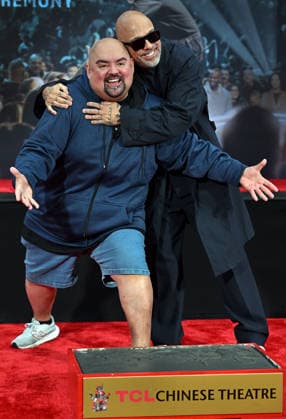 Jo Koy (R) and Gabriel Iglesias ham it up for photographers at a hand and footprint ceremony honoring Koy in the forecourt of the TCL Chinese Theatre in Los Angeles, California on Wednesday, February 11, 2026.  LAP20260211706 CHRISxCHEW