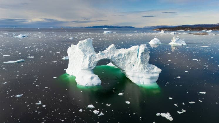 Arctic ice arch in serene Ilulissat waters A stunning ice arch formation floats in the calm Arctic waters near Ilulissat, Greenland, reflecting a breathtaking scene of natural beauty under a partly cloudy sky. Model Released NicoescobarPhoto_ID32799_1116433_002 Copyright: xNicoescobarxPhotox RECORD DATE NOT STATED