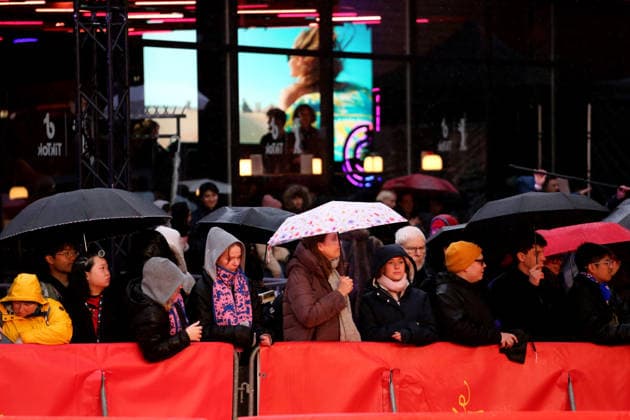 February 12, 2026, Berlin, Germany: Spectators shelter under umbrellas from the rain as they wait for guests to arrive on the red carpet at the opening ceremony of the 76th Berlin International Film Festival (Berlinale), which is Europe s first major film festival of the year, in Berlin. The festival runs from February 12 to 22, 2026. Berlin Germany  - ZUMAf146 20260212_zip_f146_074 Copyright: xRouzbehxFouladix