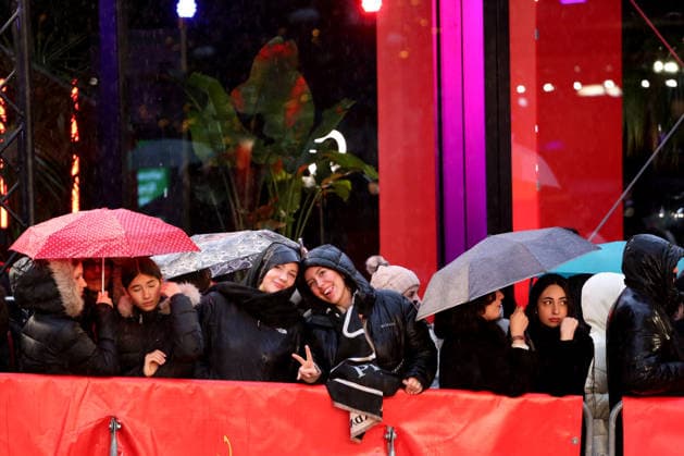 February 12, 2026, Berlin, Germany: Spectators shelter under umbrellas from the rain as they wait for guests to arrive on the red carpet at the opening ceremony of the 76th Berlin International Film Festival (Berlinale), which is Europe s first major film festival of the year, in Berlin. The festival runs from February 12 to 22, 2026. Berlin Germany - ZUMAf146 20260212_zip_f146_071 Copyright: xRouzbehxFouladix
