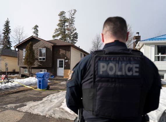 February 12, 2026, Tumbler Ridge, Bc, CANADA: An RCMP officer stands outside a home where two bodies were found in Tumbler Ridge, B.C., on Thursday, Feb. 12, 2026. Tumbler Ridge CANADA  - ZUMAc35_ 20260212_zaf_c35_195 Copyright: xChristinnexMuschix