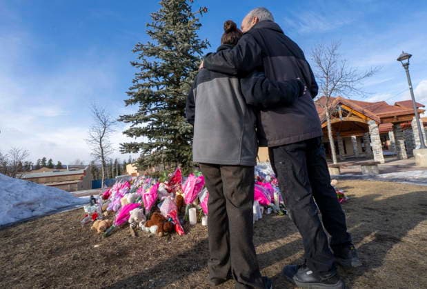 February 12, 2026, Tumbler Ridge, Bc, CANADA: A couple embrace in front of a memorial to honour the victims of a mass shooting in Tumbler Ridge, B.C., on Thursday, Feb. 12, 2026. Tumbler Ridge CANADA  - ZUMAc35_ 20260212_zaf_c35_205 Copyright: xChristinnexMuschix