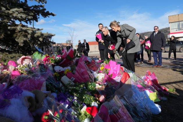 February 13, 2026, Tumbler Ridge, Bc, CANADA: Prime Minister Mark Carney and his wife Diana Fox Carney place flowers at a memorial for the victims of a mass shooting, in Tumbler Ridge, B.C., Friday, Feb. 13, 2026. Tumbler Ridge CANADA  - ZUMAc35_ 20260213_zaf_c35_107 Copyright: xChristinnexMuschix