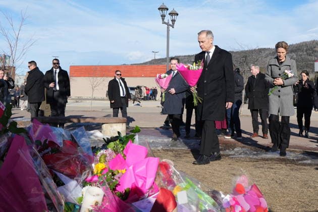 February 13, 2026, Tumbler Ridge, Bc, CANADA: Prime Minister Mark Carney and his wife Diana Fox Carney, right, arrive with NDP interim Leader Don Davies to place flowers at a memorial for the victims of a mass shooting, in Tumbler Ridge, B.C., Friday, Feb. 13, 2026. Tumbler Ridge CANADA - ZUMAc35_ 20260213_zaf_c35_116 Copyright: xChristinnexMuschix