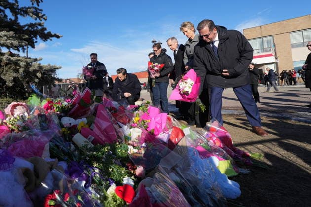 February 13, 2026, Tumbler Ridge, British Columbia, CANADA: Bloc Quebecois Leader YVES-FRANCOIS BLANCHET, right, flanked by NDP interim Leader DON DAVIES, left to right, Conservative Leader PIERRE POILIEVRE, MP BOB ZIMMER, Prime Minister MARK CARNEY and his wife DIANA FOX CARNEY, place flowers at a memorial for the victims of a mass shooting, in Tumbler Ridge. Tumbler Ridge Canada - ZUMAc35_ 20260213_zaf_c35_111 Copyright: xChristinnexMuschix