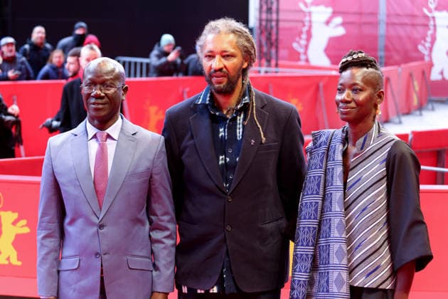 February 14, 2026, Berlin, Germany: Alain Gomis (C) and guest attends the red carpet for the film Dao premiere during the 76th Berlin International Film Festival (Berlinale), which is Europe s first major film festival of the year, in Berlin. The festival runs from February 12 to 22, 2026. Berlin Germany - ZUMAf146 20260214_zip_f146_122 Copyright: xRouzbehxFouladix