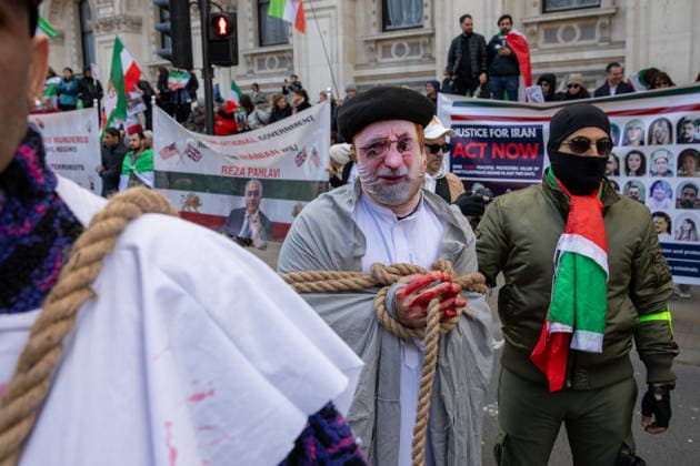 February 14, 2026, London, United Kingdom: An activist wears an Ali Hosseini Khamenei mask whilst being led by a rope through an Iranian royalist demonstration in London. Supporters of Crown Prince Reza Pahlavi gathered in Central London for a march and rally, held in coordination with demonstrations in Los Angeles, Toronto, and Munich. Participants called for the dissolution of Iran s theocratic regime and the introduction of free and fair elections, with the exiled monarch envisioned as a unifying national figurehead. London United Kingdom  - ZUMAs197 20260214_aaa_s197_175 Copyright: xJamesxWilloughbyx