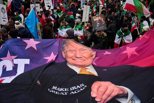 February 14, 2026, Toronto, On, Canada: Protesters carry a flag depicting United States President Donald Trump as they march in support of regime change in Iran during a demonstration in Toronto, on Saturday, Feb. 14, 2026. Toronto Canada  - ZUMAc35_ 20260214_zaf_c35_216 Copyright: xSammyxKoganx