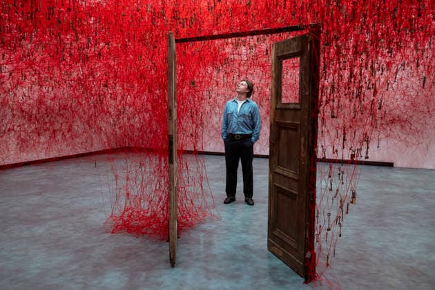 February 16, 2026, London, London, UK: LONDON, UK. A staff member with Ã¢â‚¬ËœThreads of LifeÃ¢â‚¬â ¢, 2026, at a preview of Chiharu Shiota: Threads of Life, a new exhibition by Japanese performance and installation artist Chiharu Shiota at the Hayward Gallery presenting her iconic floor-to-ceiling weblike works made of red, white and black thread. The show runs 17 February to 3 May 2026. London UK  - ZUMAl94_ 20260216_zaf_l94_004 Copyright: xStephenxChungx