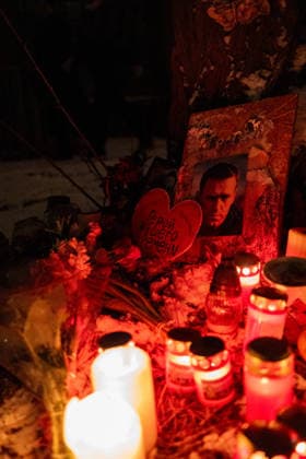 Prague Alexei Navalny Memorial Assembly People walk by a shrine of flowers and candles to Alexei Navalny, Prague, Czechia, February 16, 2026. One of the cards translates as A Hereo of Our Time. More than a hundred people came to Boris Nemtsov Square in front of the Russian embassy in Prague on the evening of February 16, 2026, to honor the memory of Russian opposition politician Alexei Navalny, who died two years ago in a Russian penal colony. Some participants carried symbolic opposition flags, where the red stripe in the tricolor is absent to protest bloodshed. Prague Czechia Czech Republic Copyright: xAlexxGistx