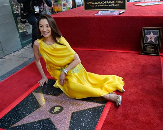 Actress Michelle Yeoh sits beside her star during an unveiling ceremony honoring her with the 2,836th star on the Hollywood Walk of Fame in Los Angeles on Wednesday, February 18, 2026.  LAP2026021820 JIMxRUYMEN