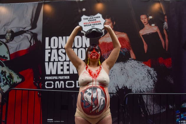 February 19, 2026, London, England, United Kingdom: A pregnant PETA activist with a picture of a baby cow painted on her belly pours fake blood over herself during a protest against leather outside the London Fashion Week NewGen space off The Strand. The action is part of the animal rights group s ongoing campaign against leather products made from animal skins and urges fashion brands and consumers to choose vegan alternatives. London United Kingdom  - ZUMAv130 20260219_zip_v130_016 Copyright: xVukxValcicx