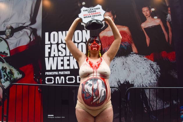 February 19, 2026, London, England, United Kingdom: A pregnant PETA activist with a picture of a baby cow painted on her belly pours fake blood over herself during a protest against leather outside the London Fashion Week NewGen space off The Strand. The action is part of the animal rights group s ongoing campaign against leather products made from animal skins and urges fashion brands and consumers to choose vegan alternatives. London United Kingdom  - ZUMAv130 20260219_zip_v130_028 Copyright: xVukxValcicx