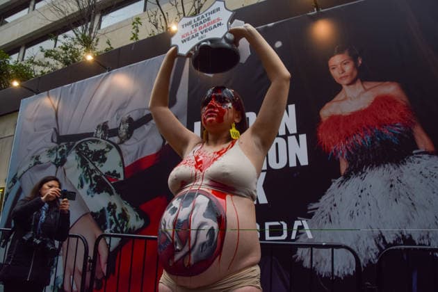 February 19, 2026, London, United Kingdom: A pregnant PETA (People for the Ethical Treatment of Animals) activist with a picture of a baby cow painted on her belly pours fake blood over herself during a protest against leather outside the London Fashion Week NewGen space off The Strand. The action is part of the animal rights group s ongoing campaign against leather products made from animal skins and urges fashion brands and consumers to choose vegan alternatives. London United Kingdom  - ZUMAs197 20260219_aaa_s197_085 Copyright: xVukxValcicx