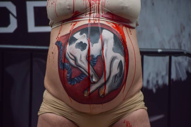 February 19, 2026, London, United Kingdom: A pregnant PETA (People for the Ethical Treatment of Animals) activist with a picture of a baby cow painted on her belly pours fake blood over herself during a protest against leather outside the London Fashion Week NewGen space off The Strand. The action is part of the animal rights group s ongoing campaign against leather products made from animal skins and urges fashion brands and consumers to choose vegan alternatives. London United Kingdom - ZUMAs197 20260219_aaa_s197_090 Copyright: xVukxValcicx