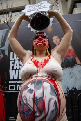 PETA Protest London Fashion Week in London - 19 Feb 2026 A PETA activist dressed as a pregnant cow and covered in fake blood, holds a placard above her head during a demonstration outside London fashion week. Members of PETA (People for the Ethical Treatment of Animals) held a demonstration outside London Fashion Week’s New Gen Space, drawing attention to the billions of animals killed annually for their skins. During the protest, a pregnant activist—wearing earrings resembling the identification tags used on cows and with an unborn calf painted on her stomach—drenched herself in red paint symbolizing blood. The demonstration conveyed the message: The Leather Trade Kills Babies — Wear Vegan. London United Kingdom Copyright: xJamesxWilloughbyx xSOPAxImagesx JWILLOUGHBY_2350