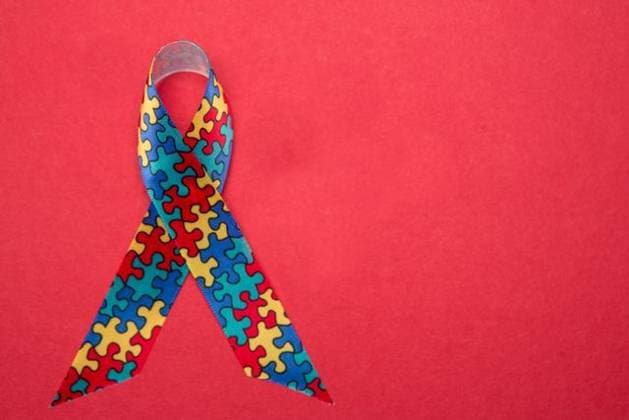 Ribbon for autism and aspergers awareness with copy space Ribbon for autism and aspergers awareness with copy space on red background, model released, Cork, Ireland, 14.01.2013, 168511.jpg, autism, aspergers, disorder, awareness, ribbon, puzzle, jigsaw, pattern, colourful, multicoloured, syndrome, condition Overhead,Single object,Studio shot