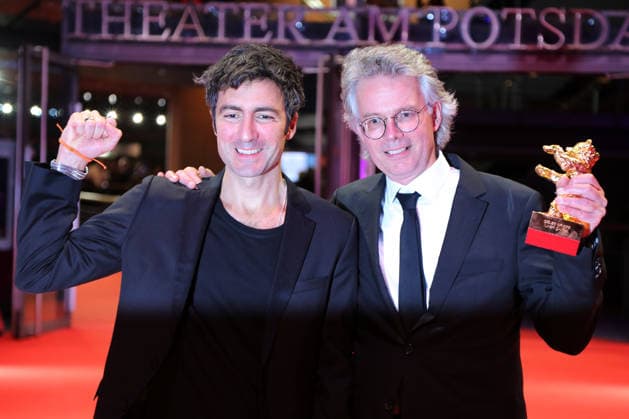 February 21, 2026, Berlin, Germany: German film director and screenwriter Ilker Catak (L) and Movie producer Ingo Fliess pose with the Golden Bear for Best Film for Gelbe Briefe (Yellow Letters) after the closing ceremony of the 76th Berlin International Film Festival (Berlinale), Europe s first major film festival of the year, in Berlin. The festival runs from February 12 to 22, 2026. Berlin Germany  - ZUMAf146 20260221_zip_f146_005 Copyright: xRouzbehxFouladix
