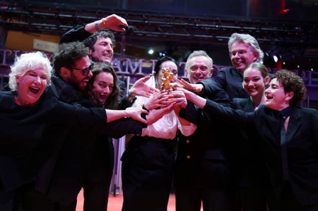 February 21, 2026, Berlin, Germany: Ilker Catak, with cast and crew pose with the Golden Bear for Best Film for Gelbe Briefe (Yellow Letters) after the closing ceremony of the 76th Berlin International Film Festival (Berlinale), Europe s first major film festival of the year, in Berlin. The festival runs from February 12 to 22, 2026. Berlin Germany  - ZUMAf146 20260221_zip_f146_009 Copyright: xRouzbehxFouladix